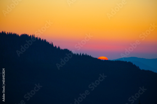 Sunrise sky over the Dragobrat in Carpathian mountains, Ukraine photo