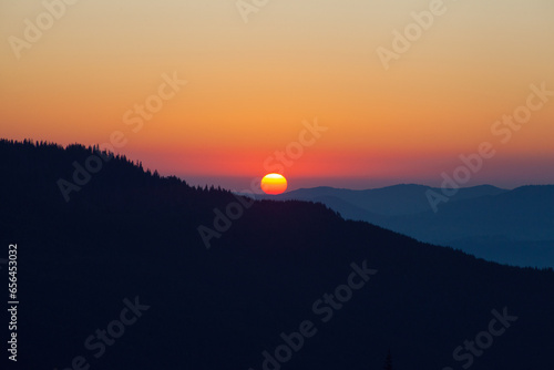 Sunrise sky over the Dragobrat in Carpathian mountains, Ukraine photo