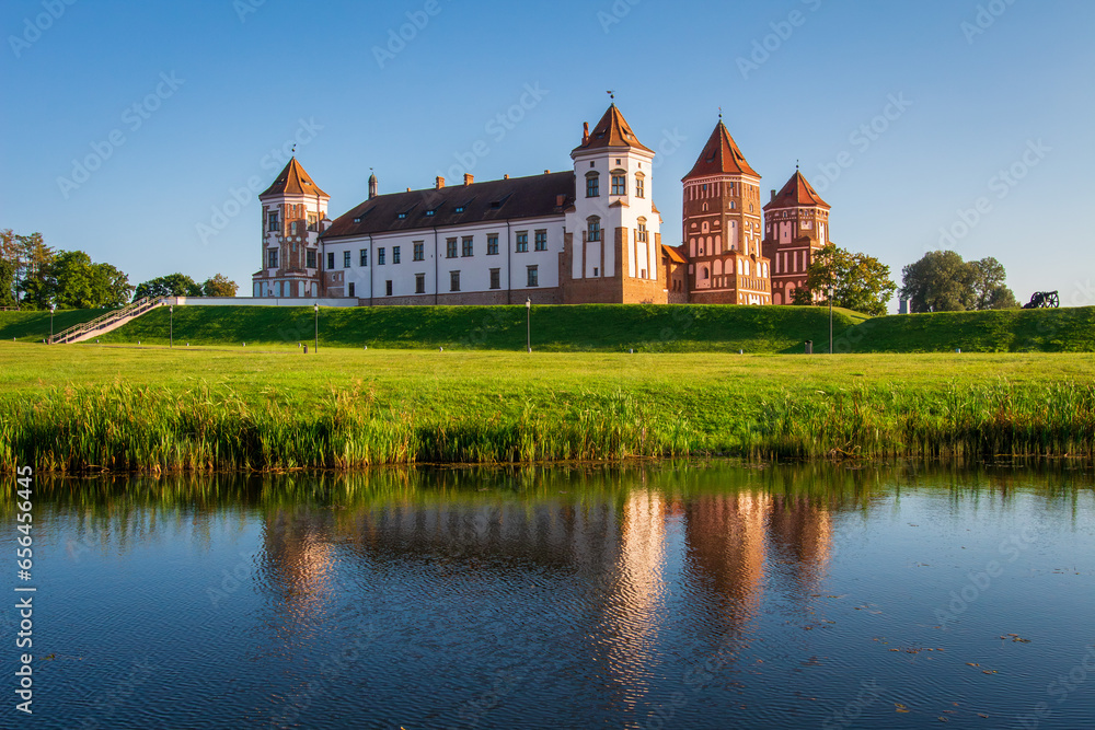 Mir Castle - historical heritage of Belarus. Scenic view of Mir Casle from the other side of the lake. Castle Complex Mir - UNESCO World Heritage.