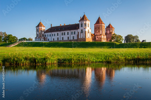 Obraz na płótnie Mir Castle - historical heritage of Belarus. Scenic view of Mir Casle from the other side of the lake. Castle Complex Mir - UNESCO World Heritage. w salonie