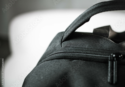 Voluminous black backpack and zipper from the lock close-up