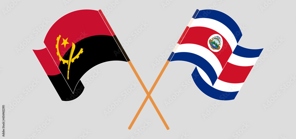 Crossed and waving flags of Angola and Costa Rica