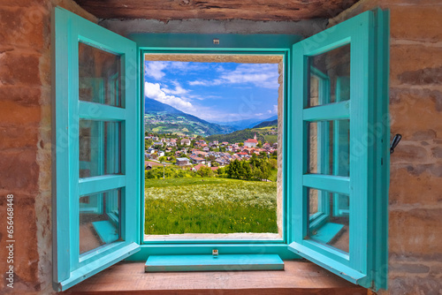 Dolomites. Idyllic alpine village of Gudon architecture and landscape view through window