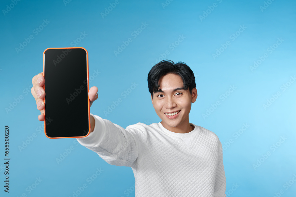 © makistock - Portrait of attractive young model presenting new smartphone for advertising