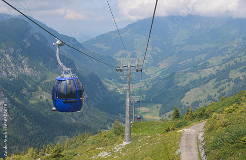 Blue chairlift where skiing goes up the mountain in autumn in Switzerland