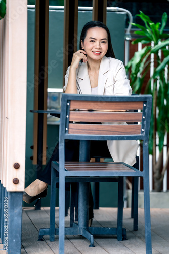 Portrait Asian businesswoman professional in grey business suit on a cafe background.Business stock photo.