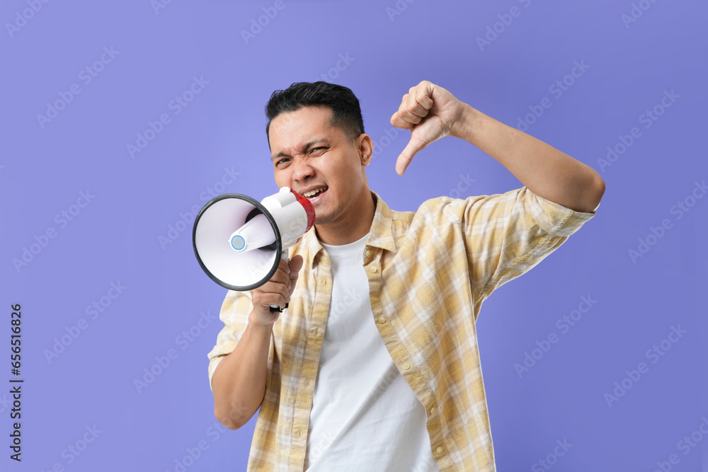 Photo of Asian man using megaphone for protests, calling to action. Photo of Asian man using megaphone for protests, calling to action.