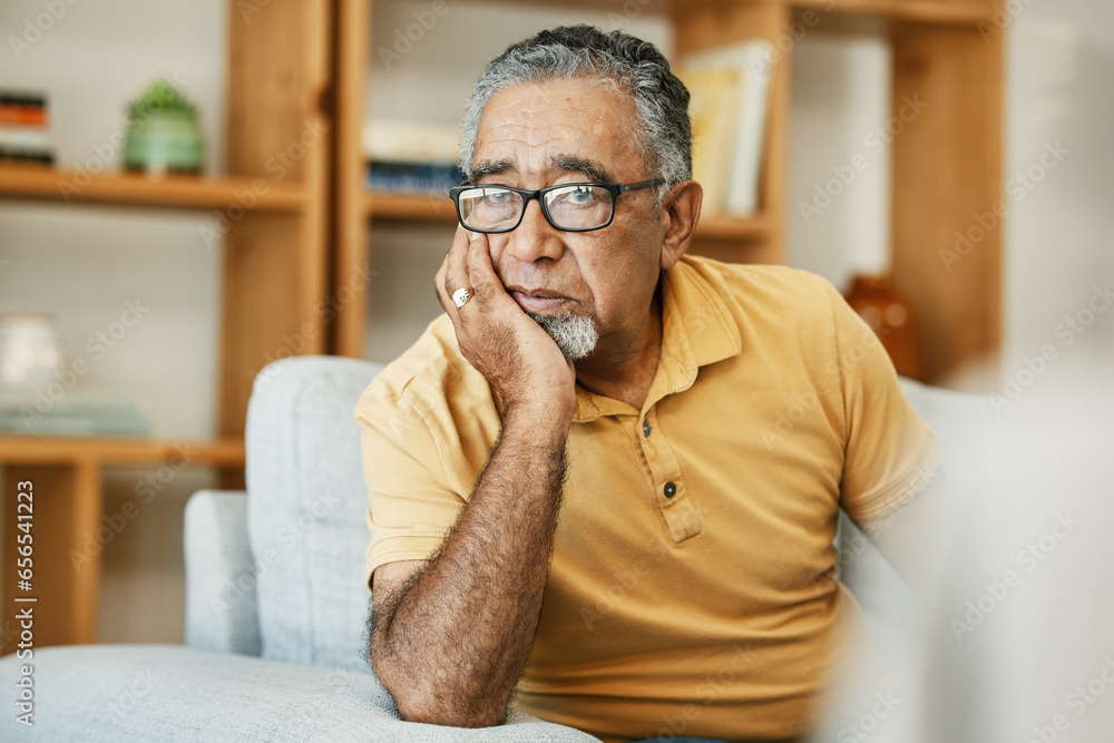Face, mental health and thinking with a sad old man on a sofa in the living room of his retirement home. Depression, alzheimer or dementia and a senior person looking lonely with memory nostalgia Face, mental health and thinking with a sad old man on a sofa in the living room of his retirement home. Depression, alzheimer or dementia and a senior person looking lonely with memory nostalgia