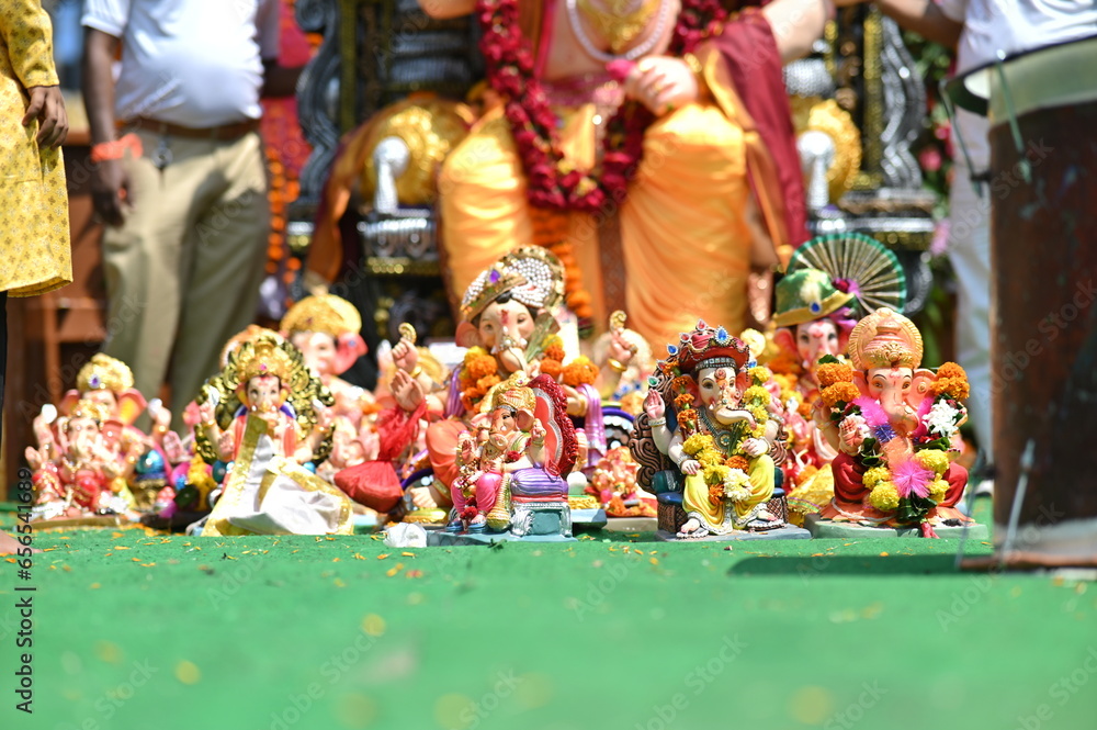 Collection of small statues of the lord Ganesha in the street. God with Elephant face. Big