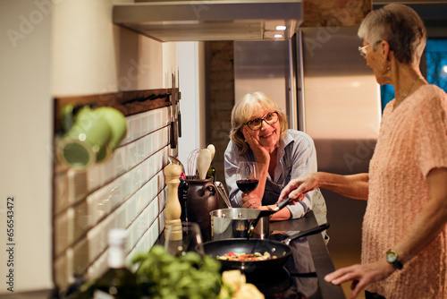 Senior lesbian couple preparing a organic dinner in the kitchen photo