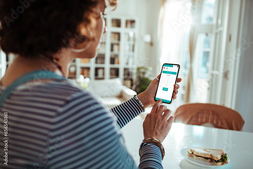 Young woman using a health app on her smartphone at home