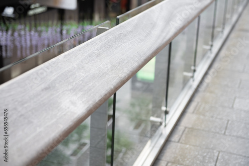 Wooden railing with tempered glass of walk way balcony. photo