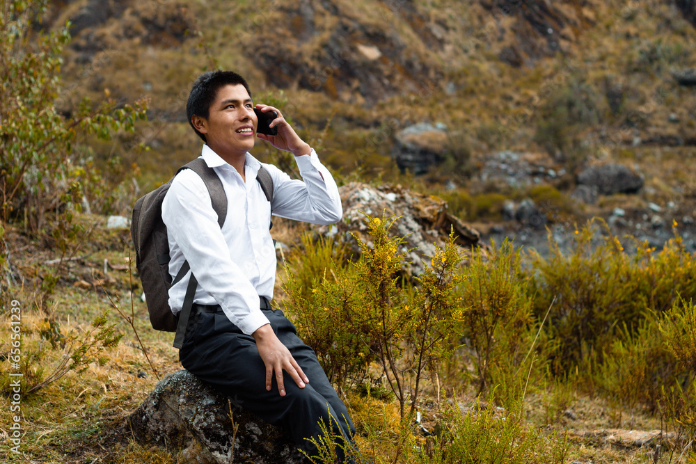 Φωτογραφία Una foto de una chico campesino alumno caucásico usando un smartphone durante la