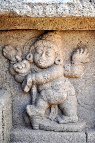 Bas relief of hindu God sculpture in temple pillar. Ancient God sculpture carved in stone wall at Airavatesvara Temple in Darasuram, Kumbakonam, Tamilnadu.