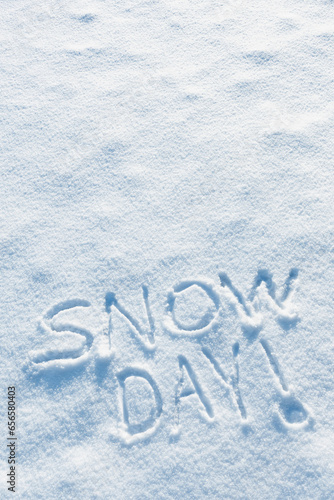 Somebody wrote SNOW DAY in the freshly fallen snow on cold Winter morning. Schools and or work places are closed because of the dangerous conditions.