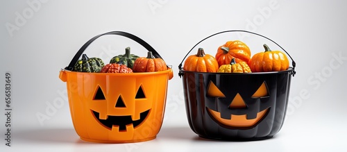 Unoccupied pumpkin buckets and buckets with Halloween treats with copyspace for text