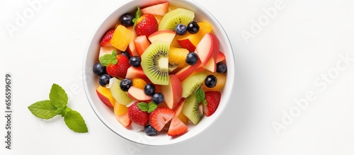 Fresh fruit salad top view white background with copyspace for text