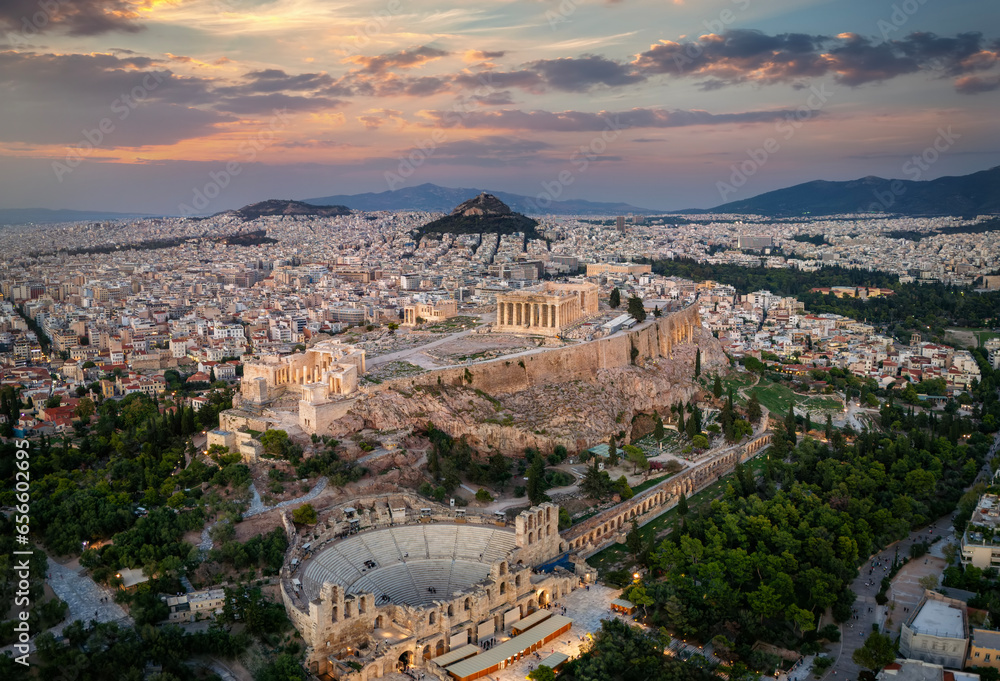 Panoramic aerial view of the Parthenon Temple and the Odeon of Herodes Atticus Theatre at the Acropolis of Athens, Greece, during sunset time