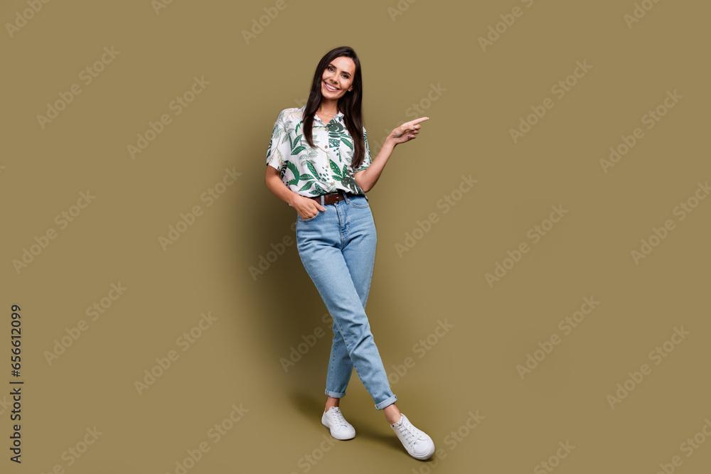 Full body portrait of lovely positive lady indicate finger empty space proposition isolated on brown color background Full body portrait of lovely positive lady indicate finger empty space proposition isolated on brown color background