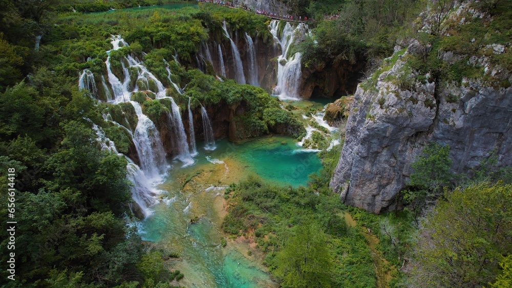 Beautiful waterfall in green forest, aerial top down view. Summer mountain landscape. Famous landmark and tourist attraction. Beautiful waterfall in green forest, aerial top down view. Summer mountain landscape. Famous landmark and tourist attraction.