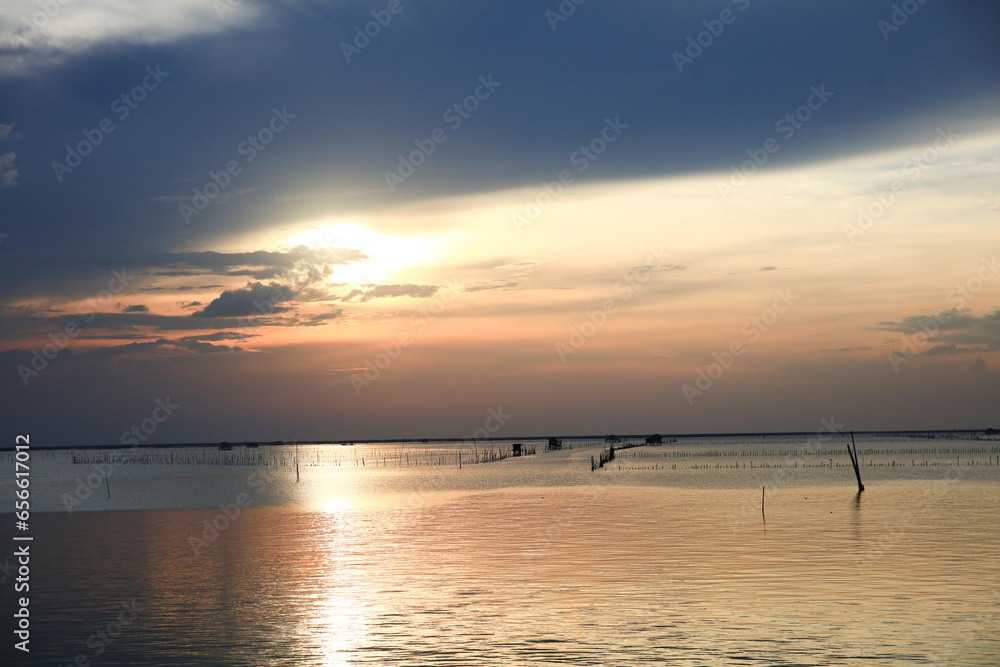 Lifestyle of fisherman with motor fisherman boat with sunset sky Lifestyle of fisherman with motor fisherman boat with sunset sky