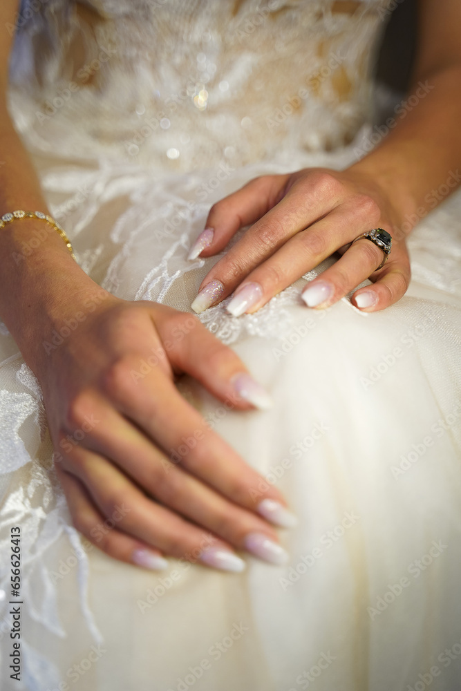hands of the bride with white fingernails and jewerlery hands of the bride with white fingernails and jewerlery