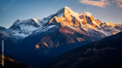 Panoramic view of snow-capped mountain peaks at sunrise