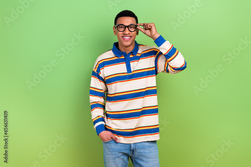 Photo of touching new gucci glasses guy striped stylish polo shirt candid model posing business manager isolated on green color background