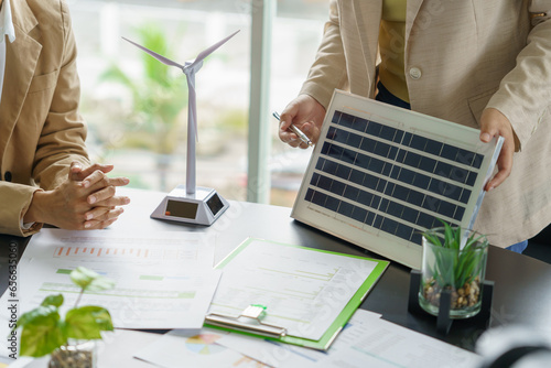 Solar panels green energy Business people working in green eco friendly office business meeting creative ideas for business eco friendly professional teaching corporate people sustainable electricity
