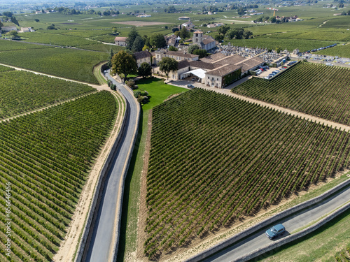 Harvest time in Saint-Emilion medieval village, wine making region on right bank of Bordeaux, ready to harvest Merlot or Cabernet Sauvignon red wine grapes, France in september, aerial view photo