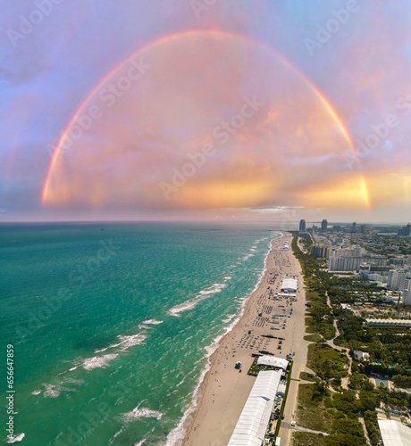 Rainbow over American southern seashore of Miami Beach city. Tourist infrastructure in Florida, USA. South Beach high luxurious hotels and apartment buildings