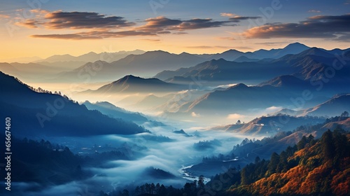 Fog rolling over a mountain range at dawn. © Creative artist1