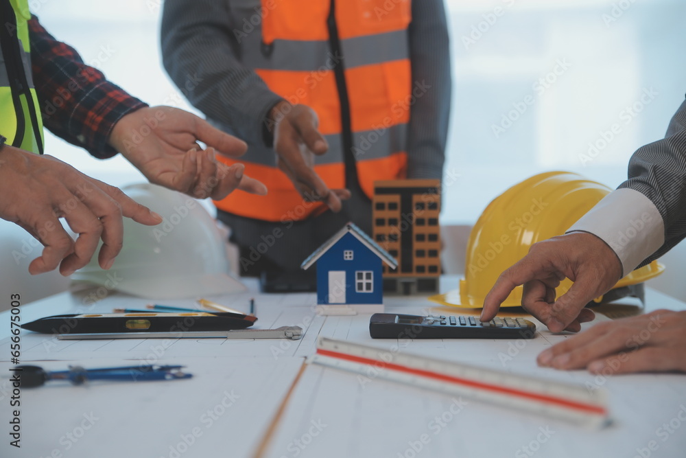 Construction and structure concept of Engineer or architect meeting for project working with partner and engineering tools on model building and blueprint in working site, contract for both companies. Construction and structure concept of Engineer or architect meeting for project working with partner and engineering tools on model building and blueprint in working site, contract for both companies.