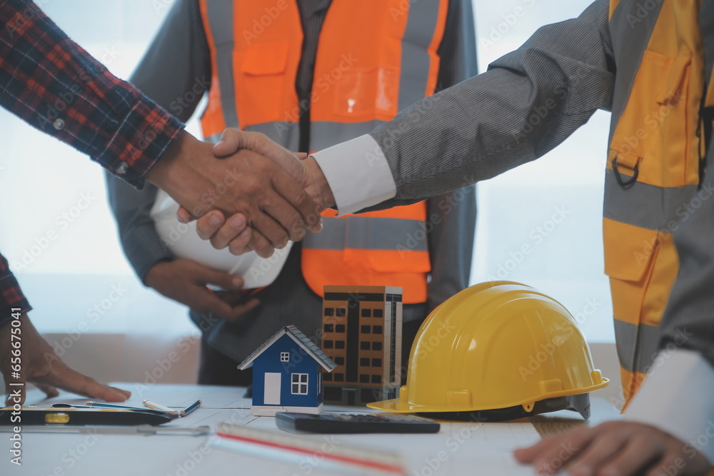 Construction and structure concept of Engineer or architect meeting for project working with partner and engineering tools on model building and blueprint in working site, contract for both companies. Construction and structure concept of Engineer or architect meeting for project working with partner and engineering tools on model building and blueprint in working site, contract for both companies.