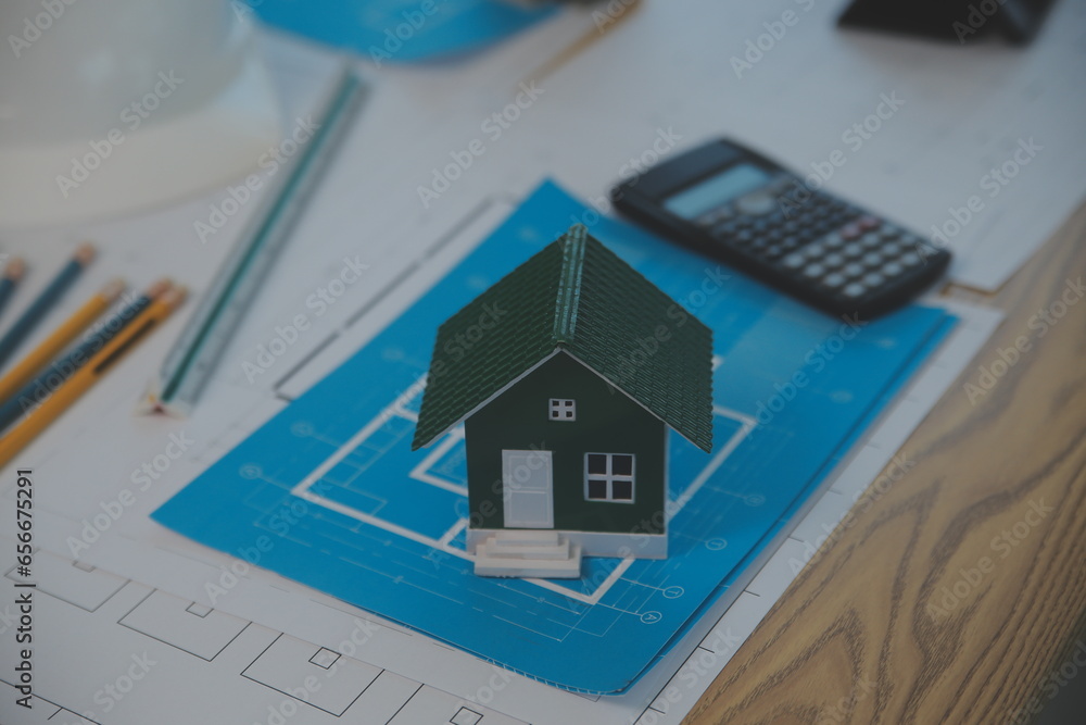 Construction and structure concept of Engineer or architect meeting for project working with partner and engineering tools on model building and blueprint in working site, contract for both companies.