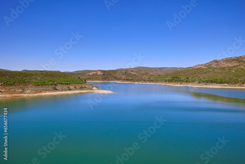 Aerial view of the reservoir with low level of water during a long drought. Forata reservoir, Valencia, Spain.