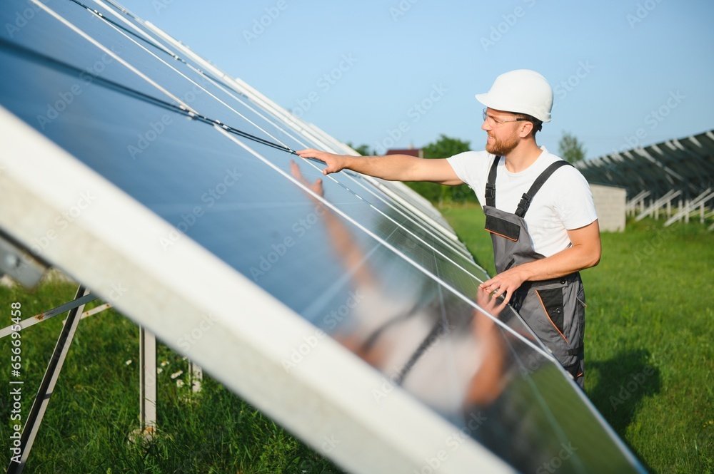 Worker installing solar panels outdoors. Worker installing solar panels outdoors.