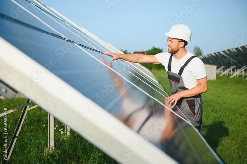 Worker installing solar panels outdoors.