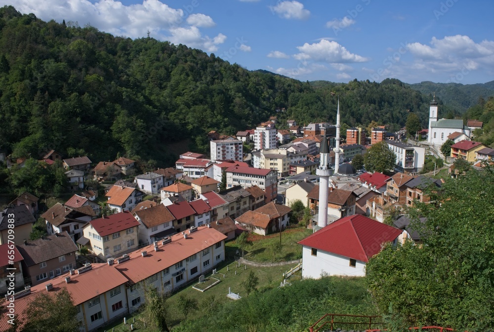 Srebrenica, Bosnia and Herzegovina - Oct 2, 2023: Distant view of Srebrenica city in Bosnia and Herzegovina federation from the surrounding viewpoints in a sunny autumn afternoon. Selective focus.