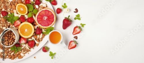 Healthy breakfast concept with muesli fruit salad orange juice nuts on a white background with copyspace for text