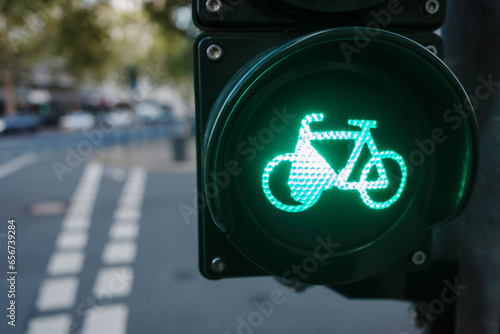 Selective focus at green traffic light with bicycle sign over bicycle lane.  photo