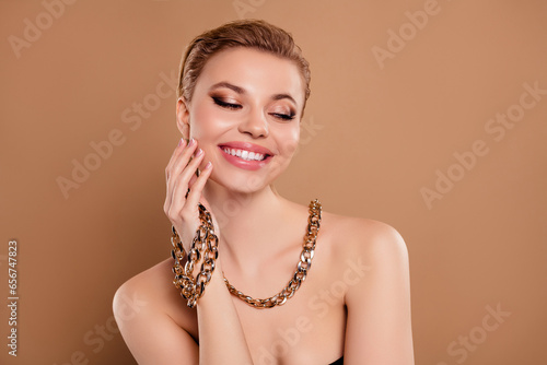 Photo of happy joyful lady touch face wear precious jewelry assortment for 14 february present on beige background