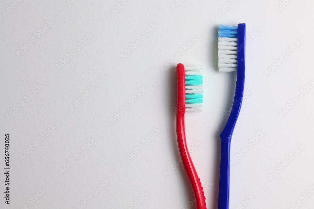 Different toothbrushes on a colored background. Dental care, oral health. Different toothbrushes on a colored background. Dental care, oral health.