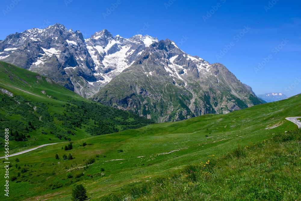 Mountains and alpine meadows views near Col du Lautaret, Massif des Ecrins, Hautes Alpes, France in summer