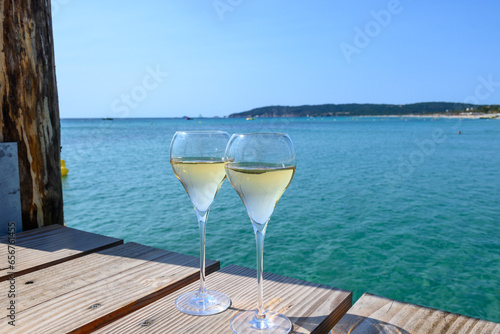 Summer time in Provence  two glasses of cold champagne cremant sparkling wine on famous Pampelonne sandy beach near Saint-Tropez in sunny day  Var department  France