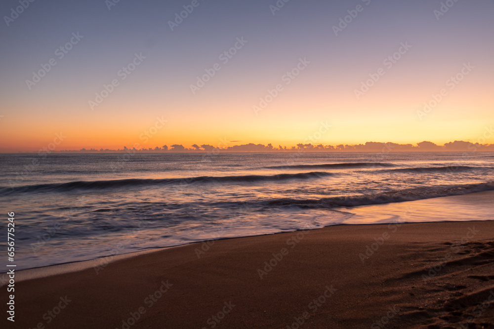 Waves crashing during sunrise on the beach
