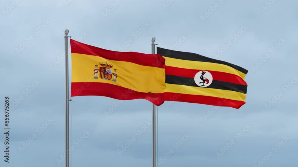 Republic of Uganda and Spain flag waving together on cloudy sky, endless seamless loop, two country cooperation concept Republic of Uganda and Spain flag waving together on cloudy sky, endless seamless loop, two country cooperation concept