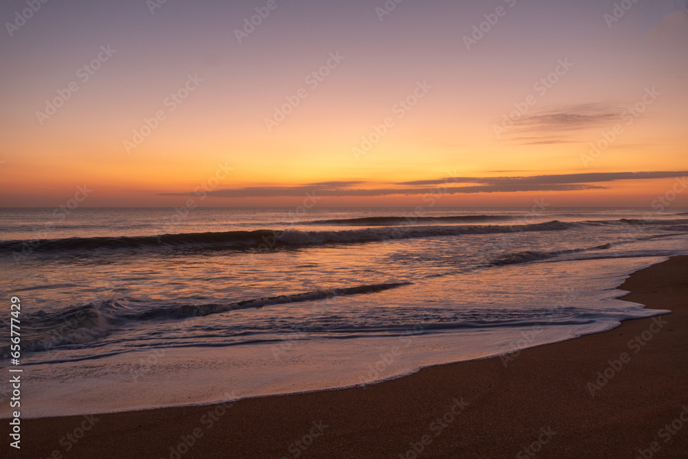 Sunrise on Florida beach, reflections on the sand