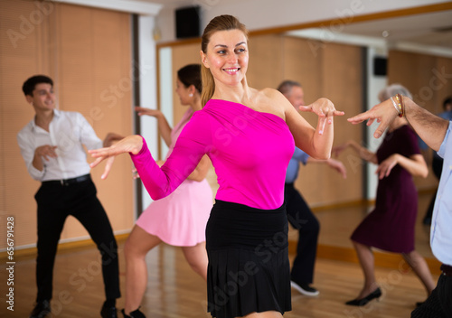 Professional female dancer rehearsing ballroom dances in dance studio