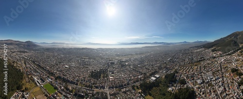 Schilderij op canvas Aerial shot of Quito early in the morning, where you can see lots of volcanos